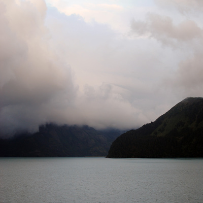 clouds and mountains on the alaska waters